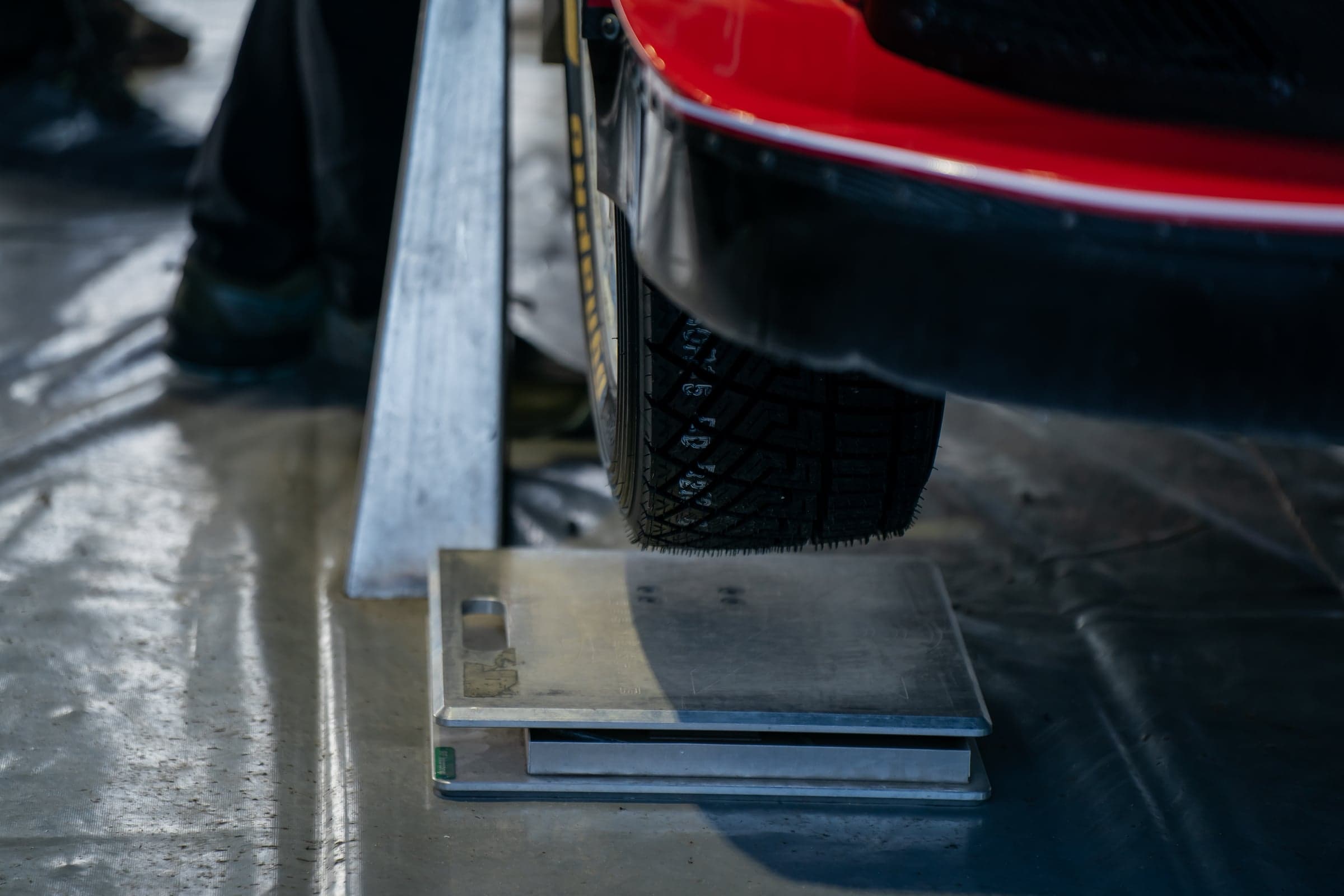 A vehicle tire resting on a certified precision wheel scale during a weight check